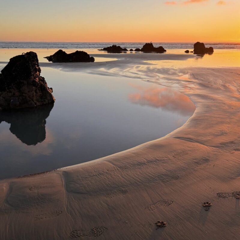 Rock pools at Sumner beach at sunset