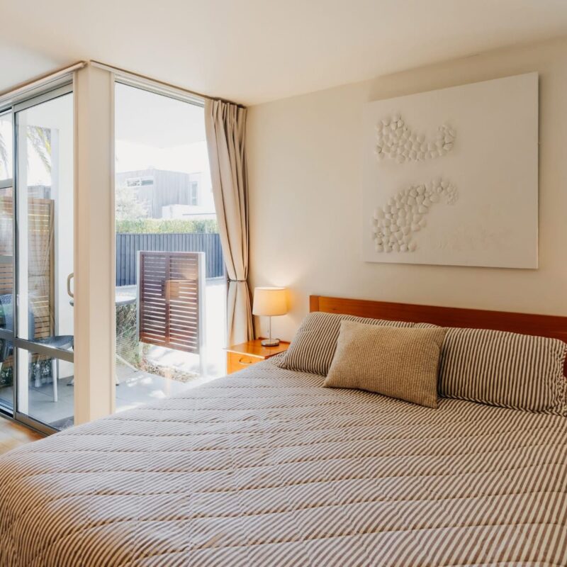 Light-filled bedroom at corporate accommodation Christchurch with queen bed